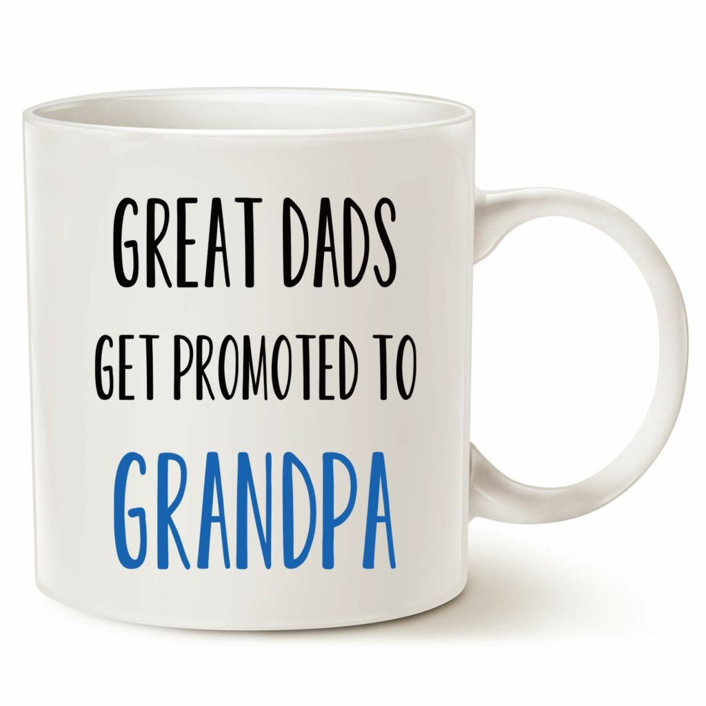 White mug reading in all caps, black text: GREAT DADS GET PROMOTED TO" and then in blue text "GRANDPA"